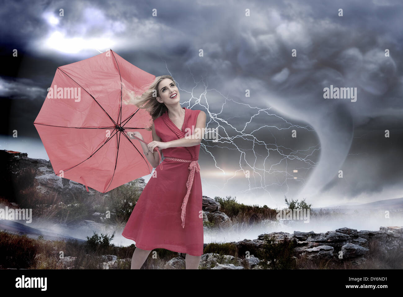 Composite image of elegant blonde holding umbrella Stock Photo