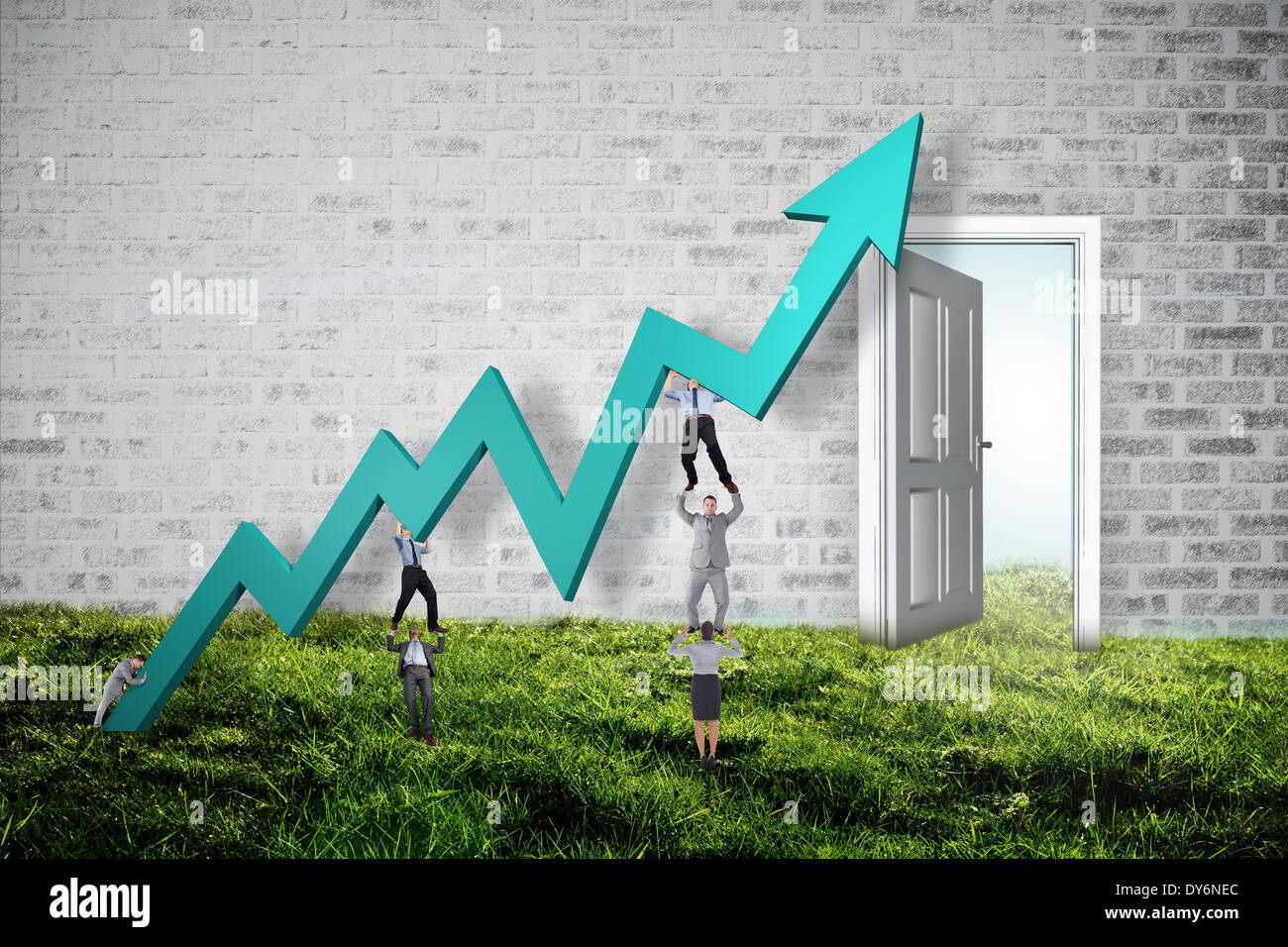 Composite image of business team holding up arrow Stock Photo - Alamy