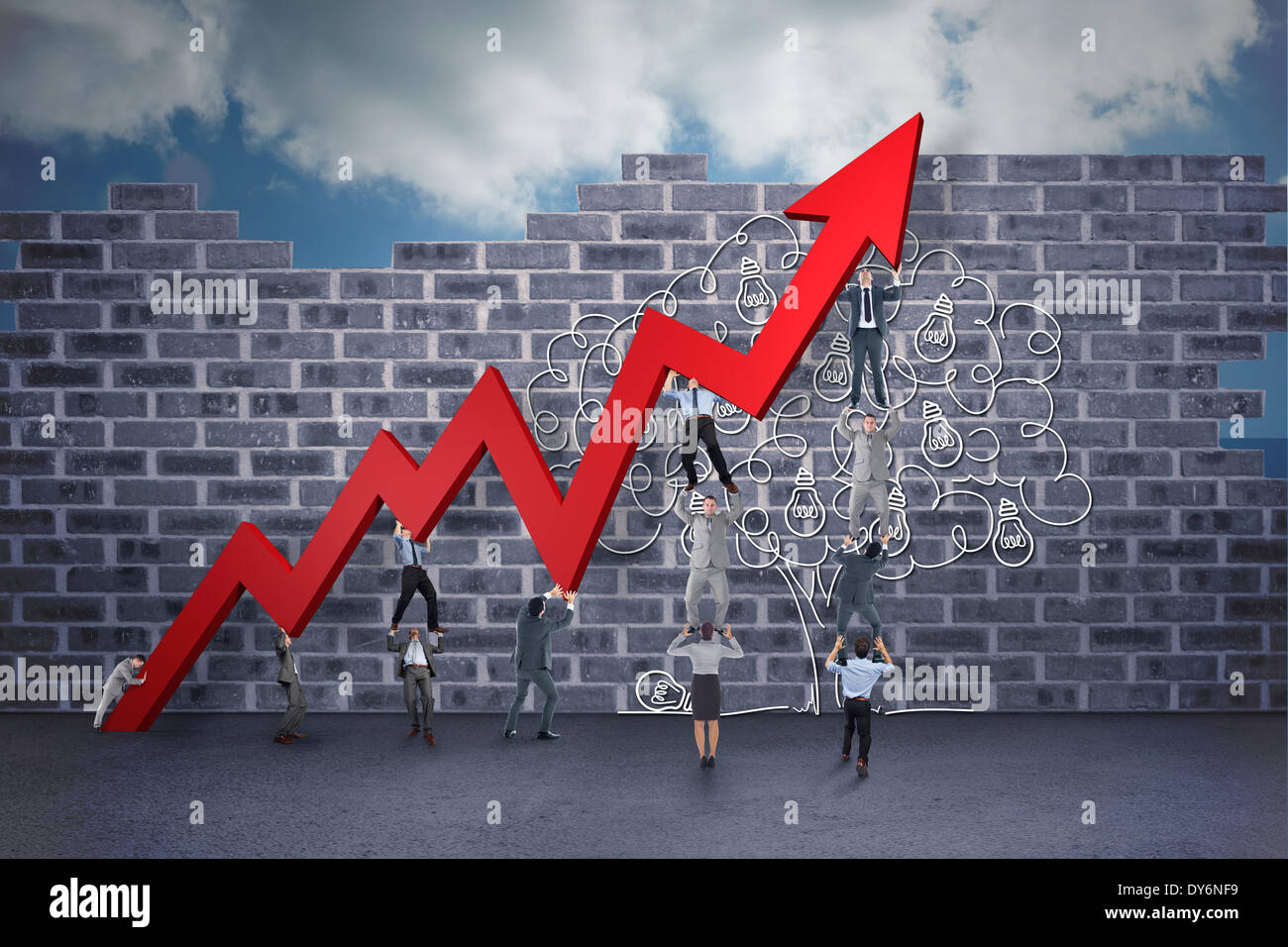 Composite image of business team holding up arrow Stock Photo - Alamy