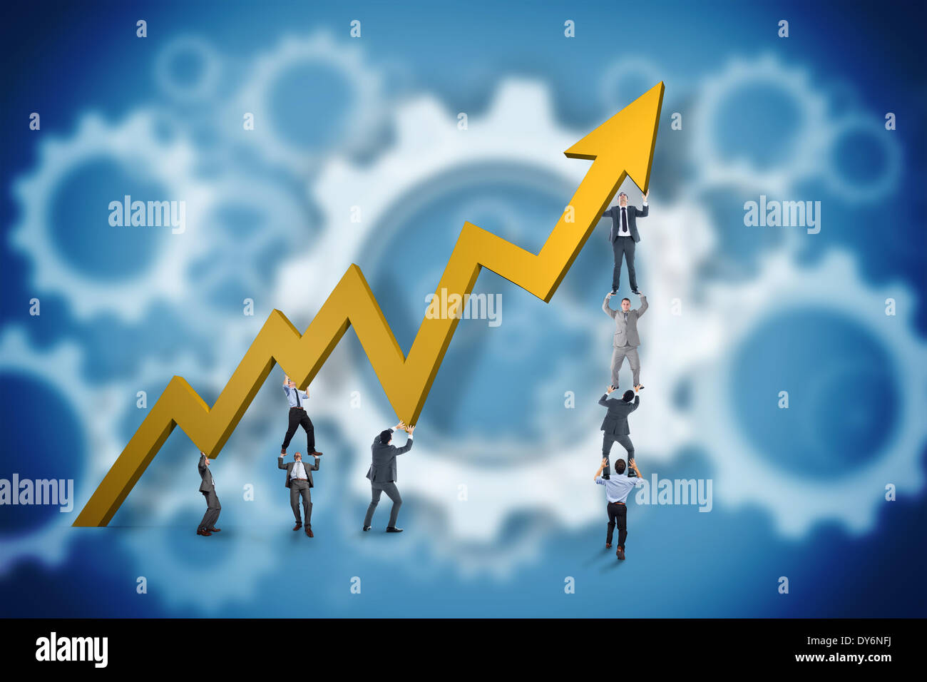Composite image of business team holding up arrow Stock Photo - Alamy