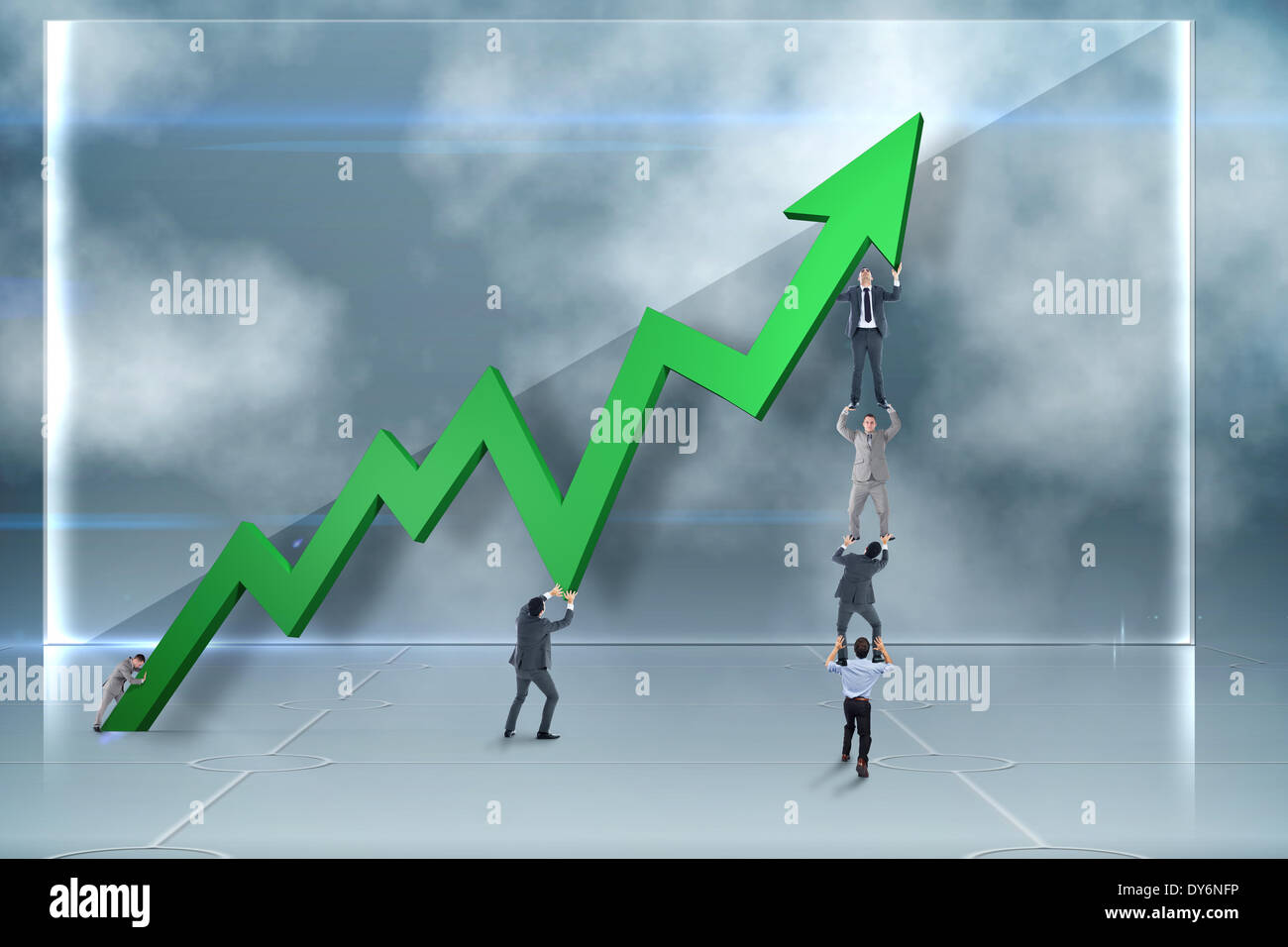 Composite image of business team holding up arrow Stock Photo - Alamy