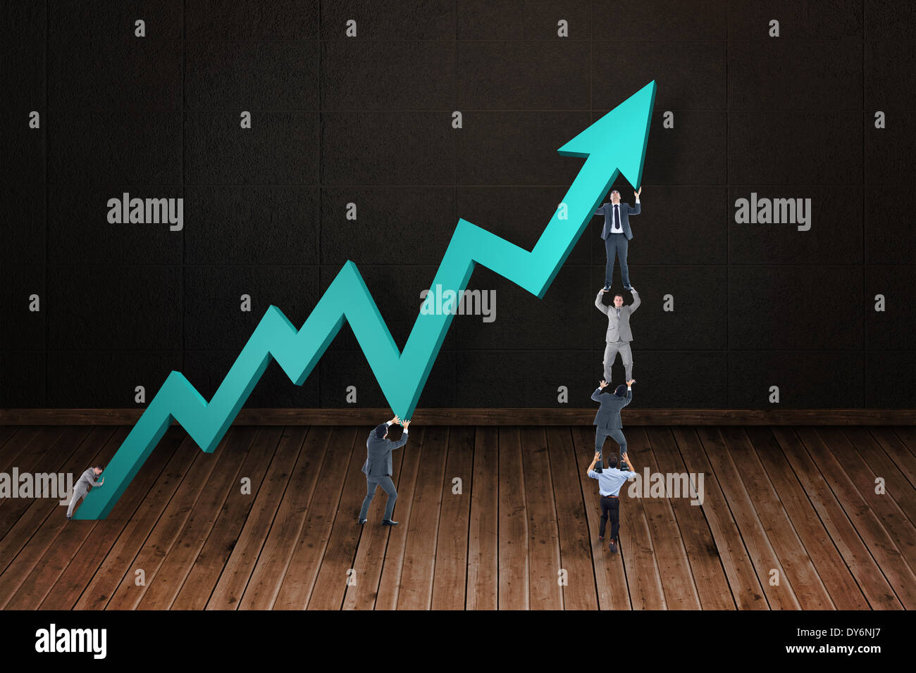 Composite image of business team holding up arrow Stock Photo - Alamy