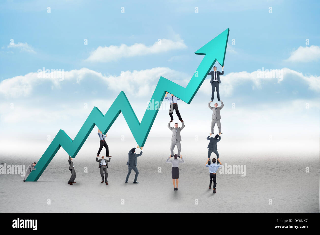 Composite image of business team holding up arrow Stock Photo - Alamy