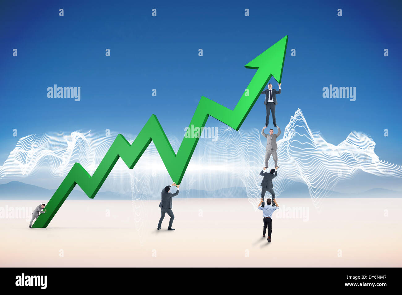 Composite image of business team holding up arrow Stock Photo