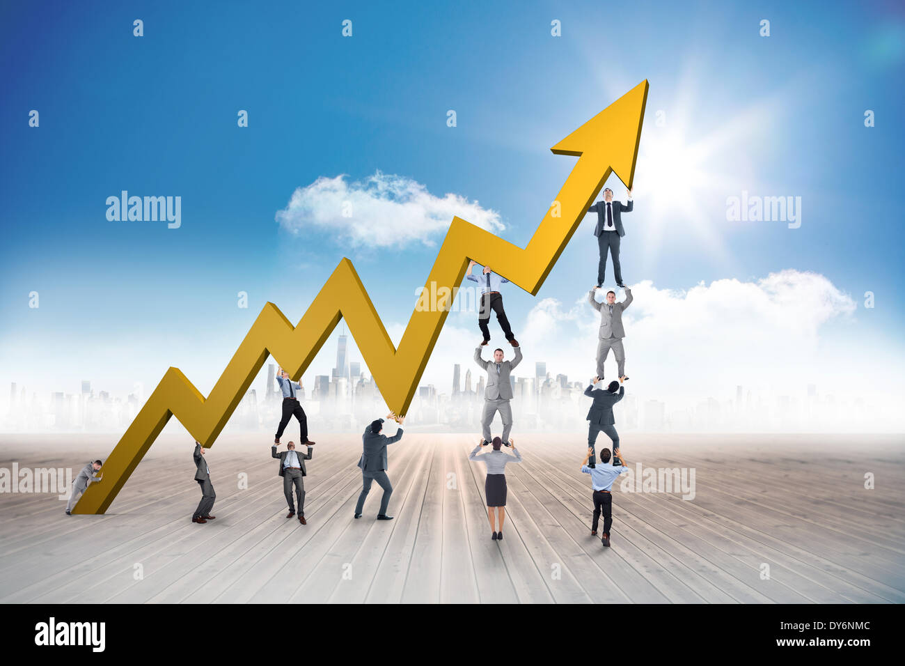 Composite image of business team holding up arrow Stock Photo - Alamy