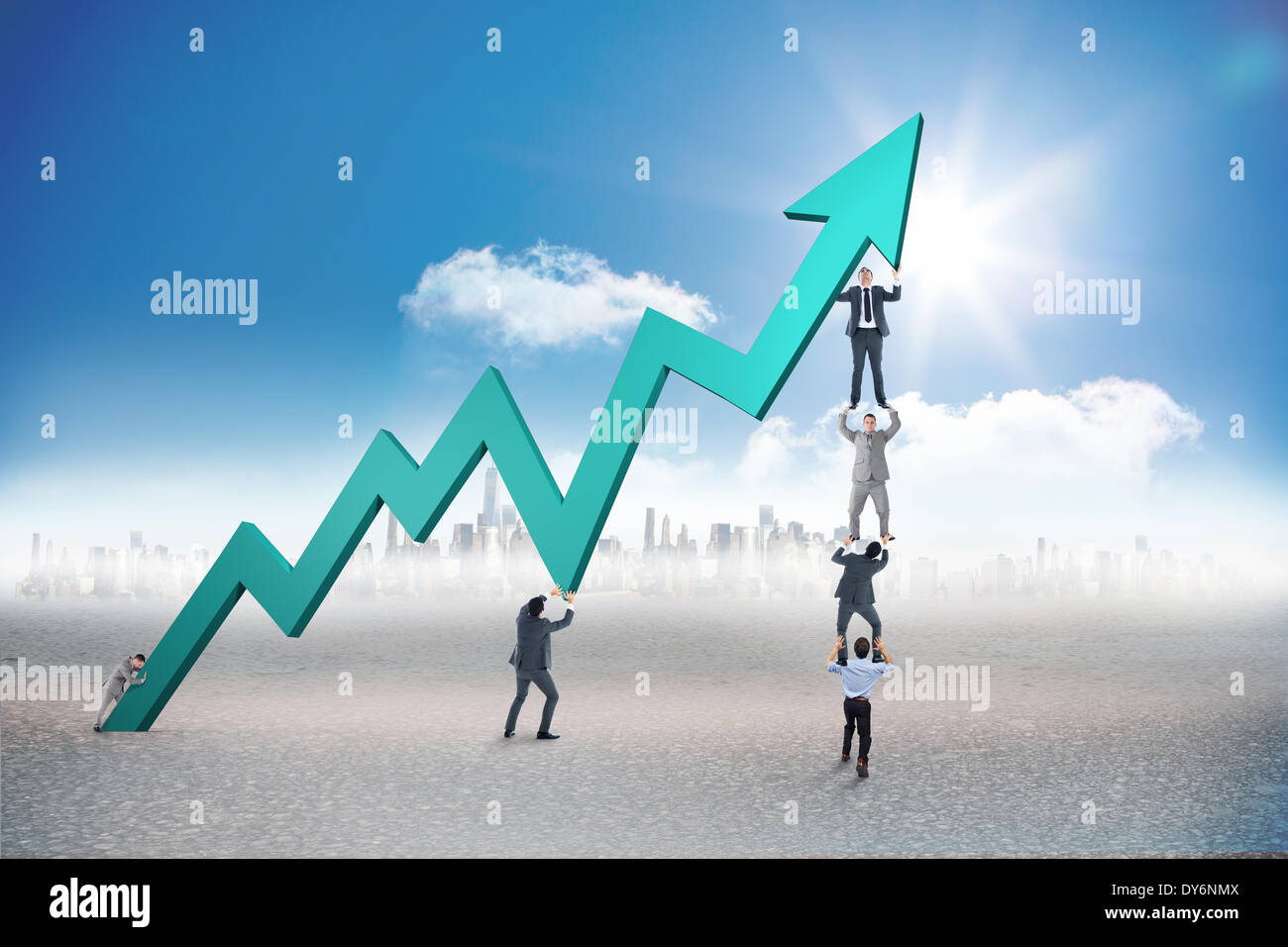 Composite image of business team holding up arrow Stock Photo - Alamy