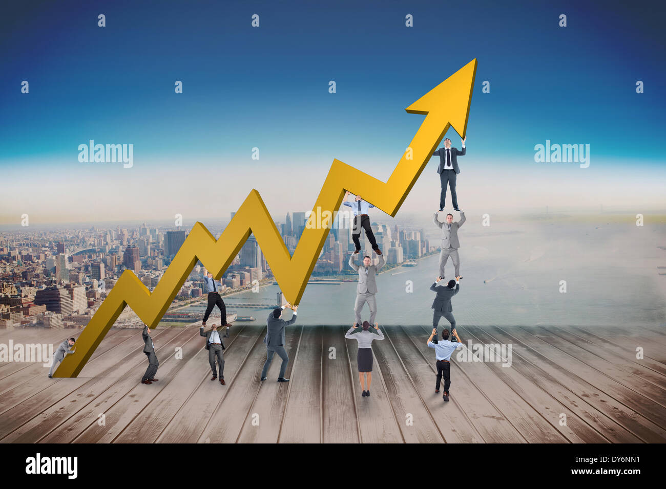 Composite image of business team holding up arrow Stock Photo - Alamy