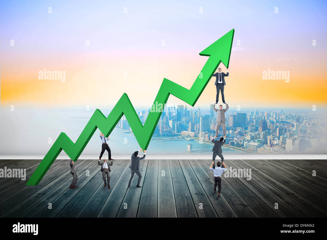 Composite image of business team holding up arrow Stock Photo - Alamy