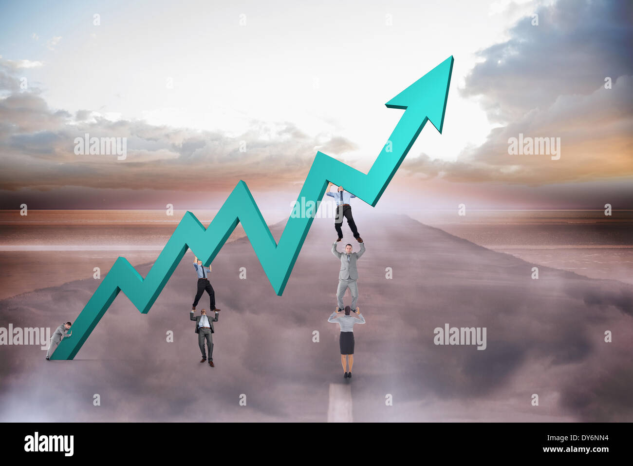 Composite image of business team holding up arrow Stock Photo - Alamy
