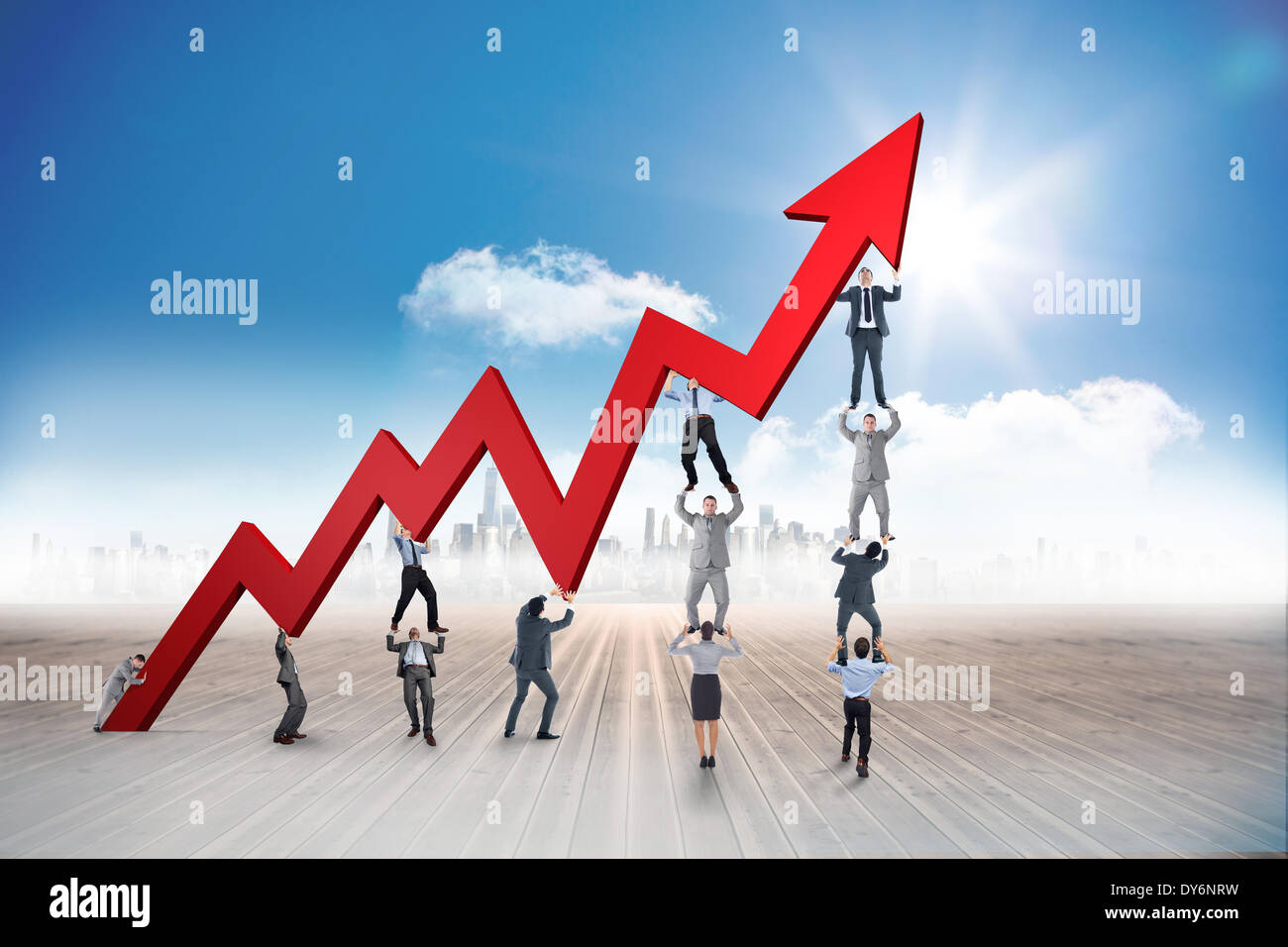 Composite image of business team holding up arrow Stock Photo - Alamy