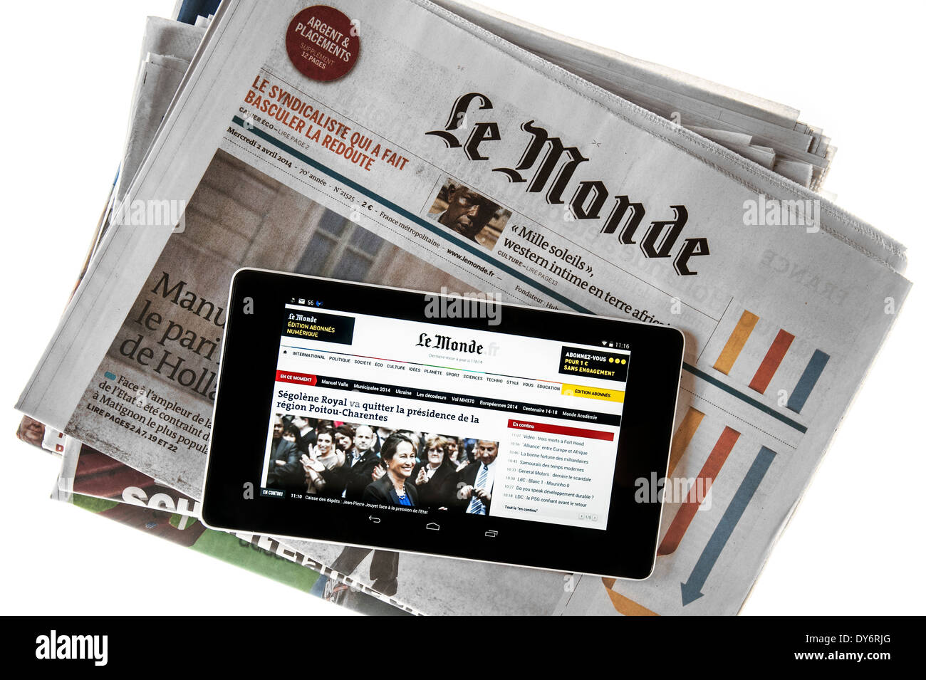 Touchscreen digital tablet showing online world news on top of French Le Monde newspaper on white background Stock Photo