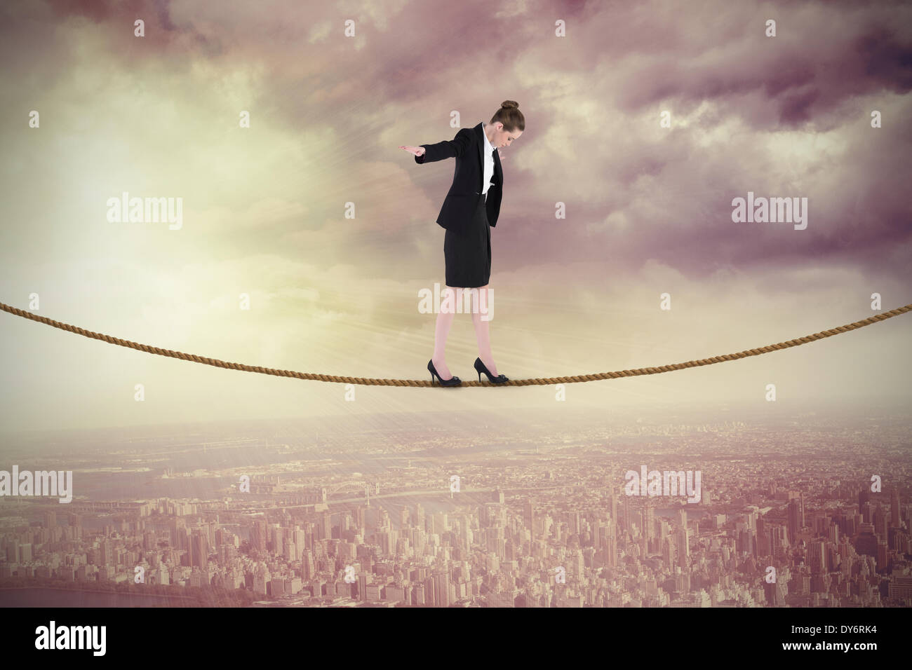 Composite image of businesswoman performing a balancing act Stock Photo