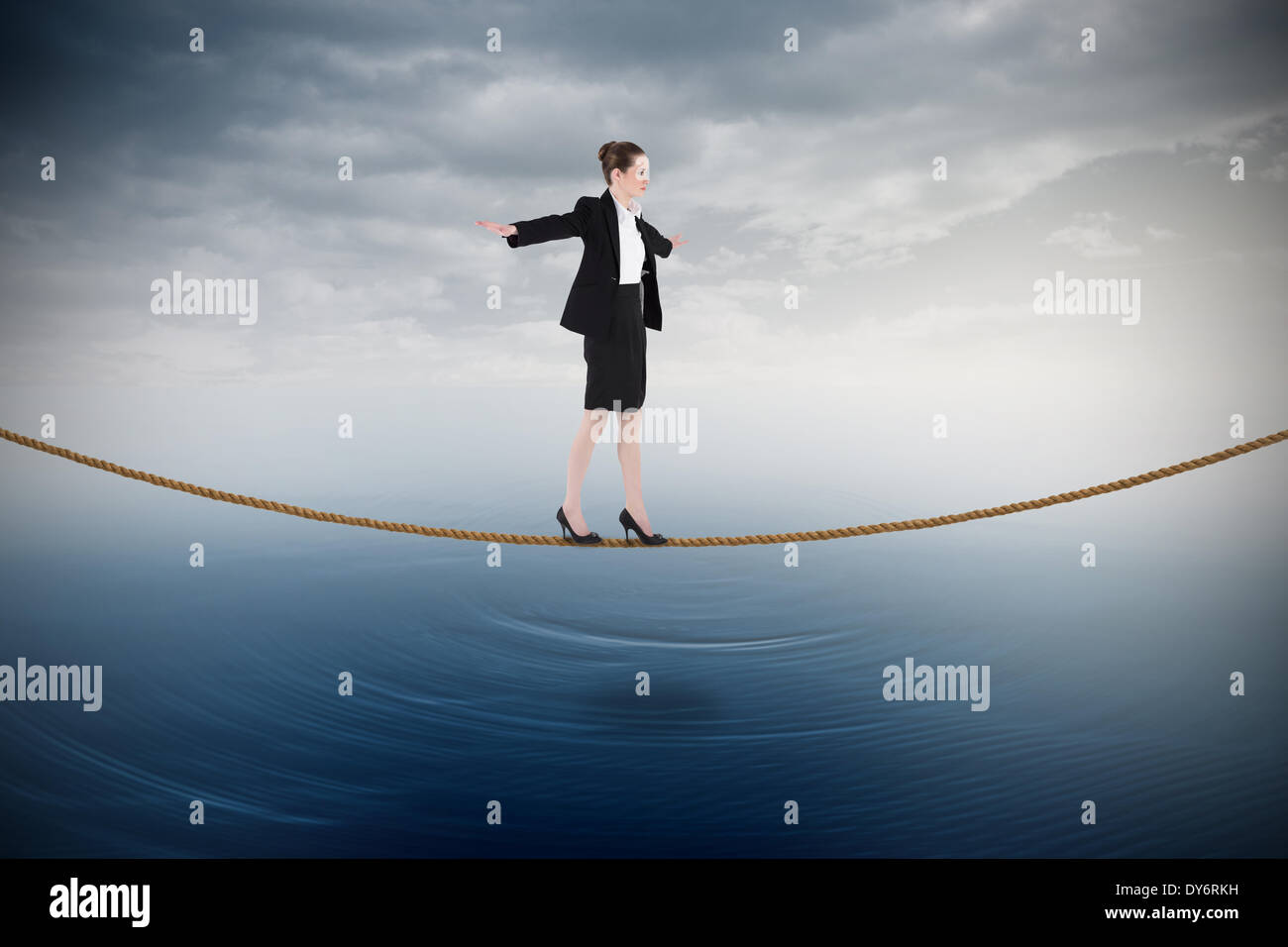Composite image of businesswoman performing a balancing act Stock Photo