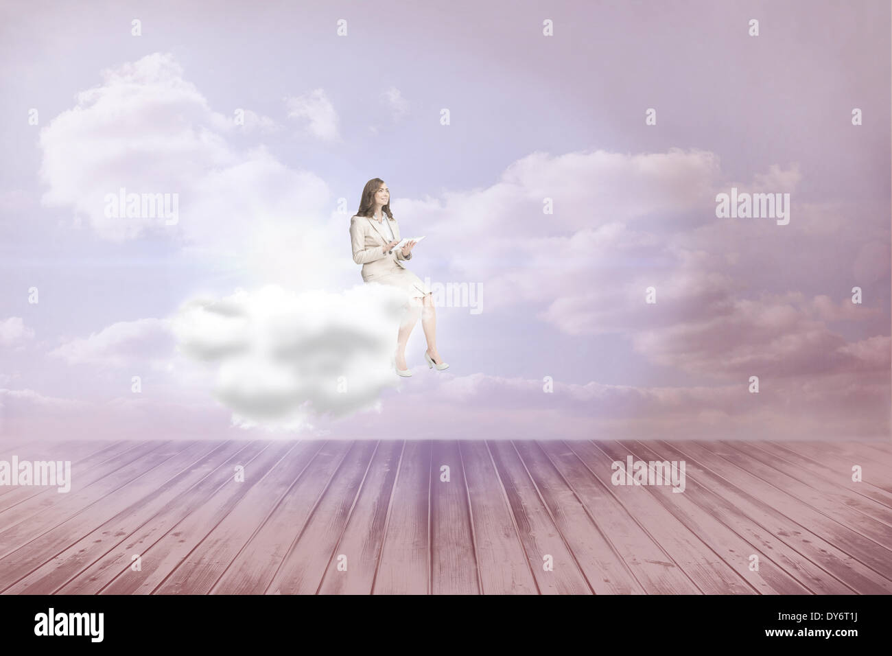 Composite image of businesswoman holding tablet and looking up Stock Photo