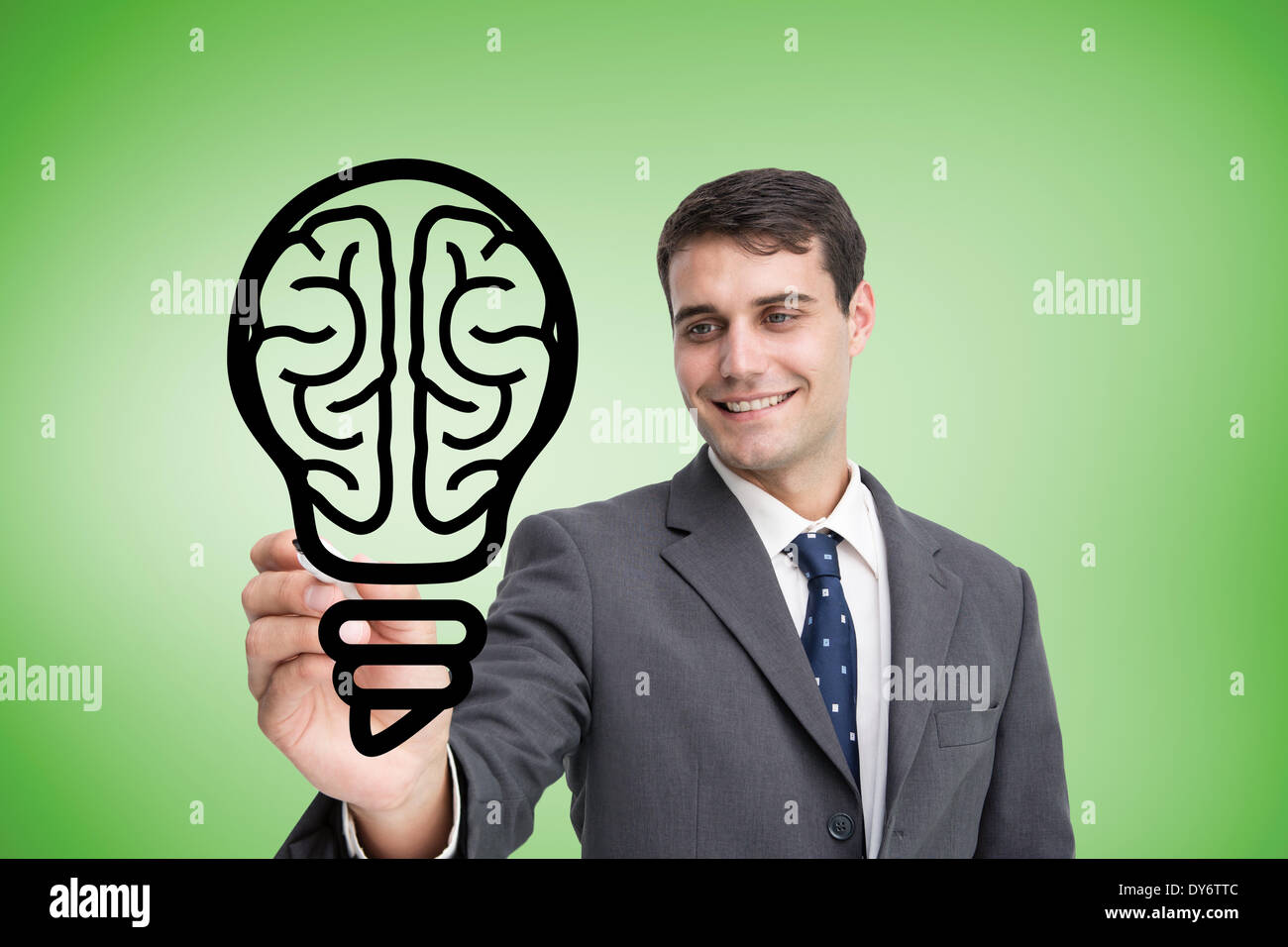 Composite image of businessman drawing light bulb Stock Photo
