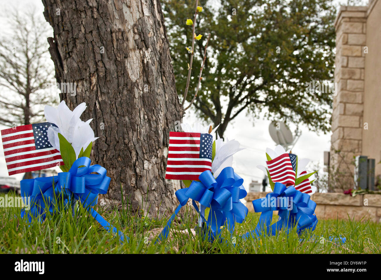 A makeshift memorial of small flags and crosses supporting the victims of the April 2 shooting next to the Fort Hood main gate April 7, 2014 in Fort Hood, Texas. Stock Photo