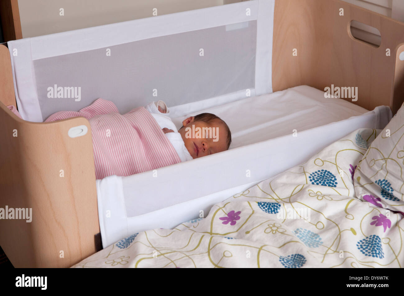 Three day old newborn baby girl asleep in her crib Stock Photo Alamy