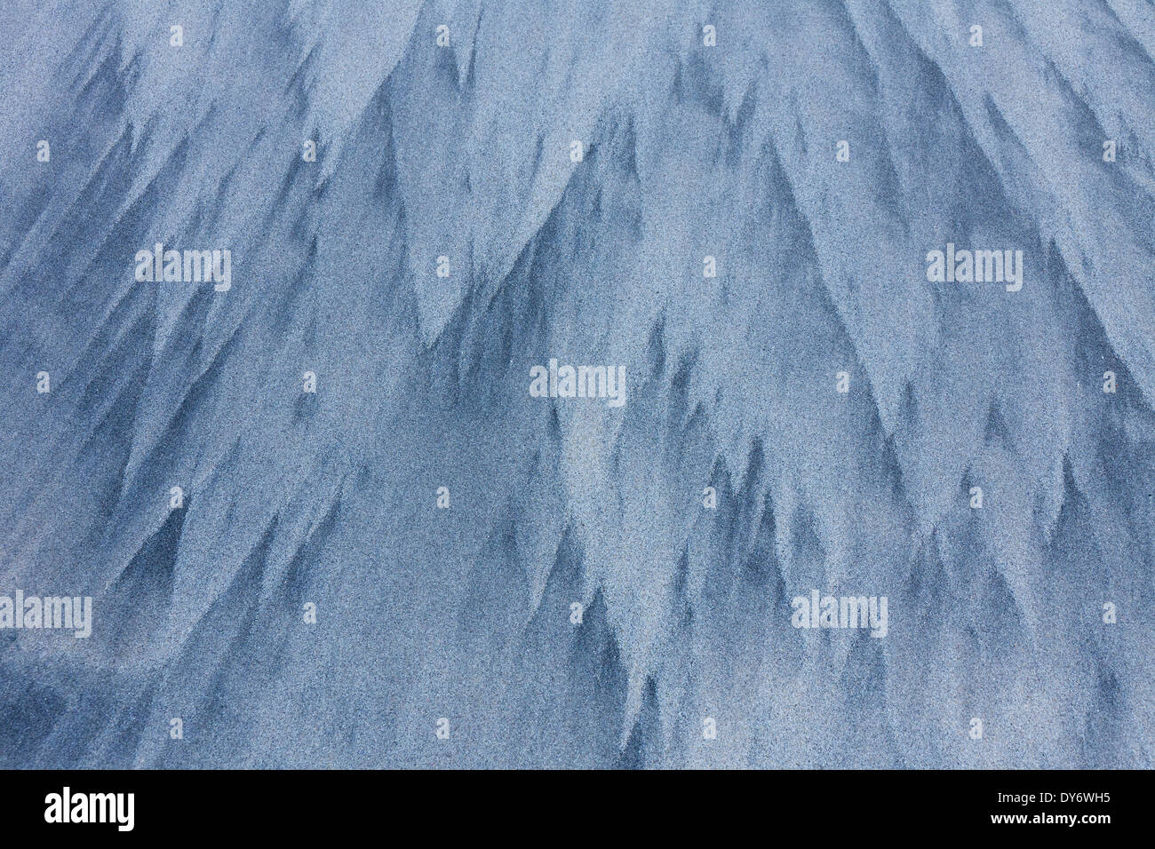 Abstract patterns in the sea sand from water erosion at beach along the coast in winter Stock Photo