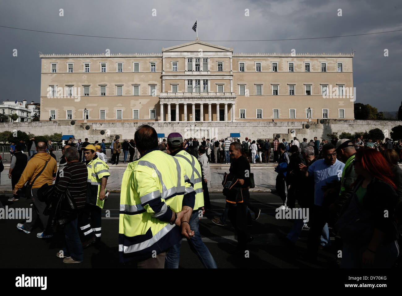 Athens, Greece. 08th Apr, 2014. Dock workers shout slogans as walk past the Greek Parliament in
