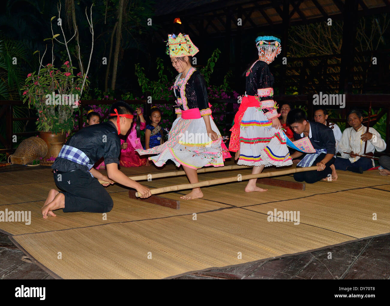 Hmong men and women perform traditional dancing at night to entertain tourists, Laos, Southeast Asia Stock Photo