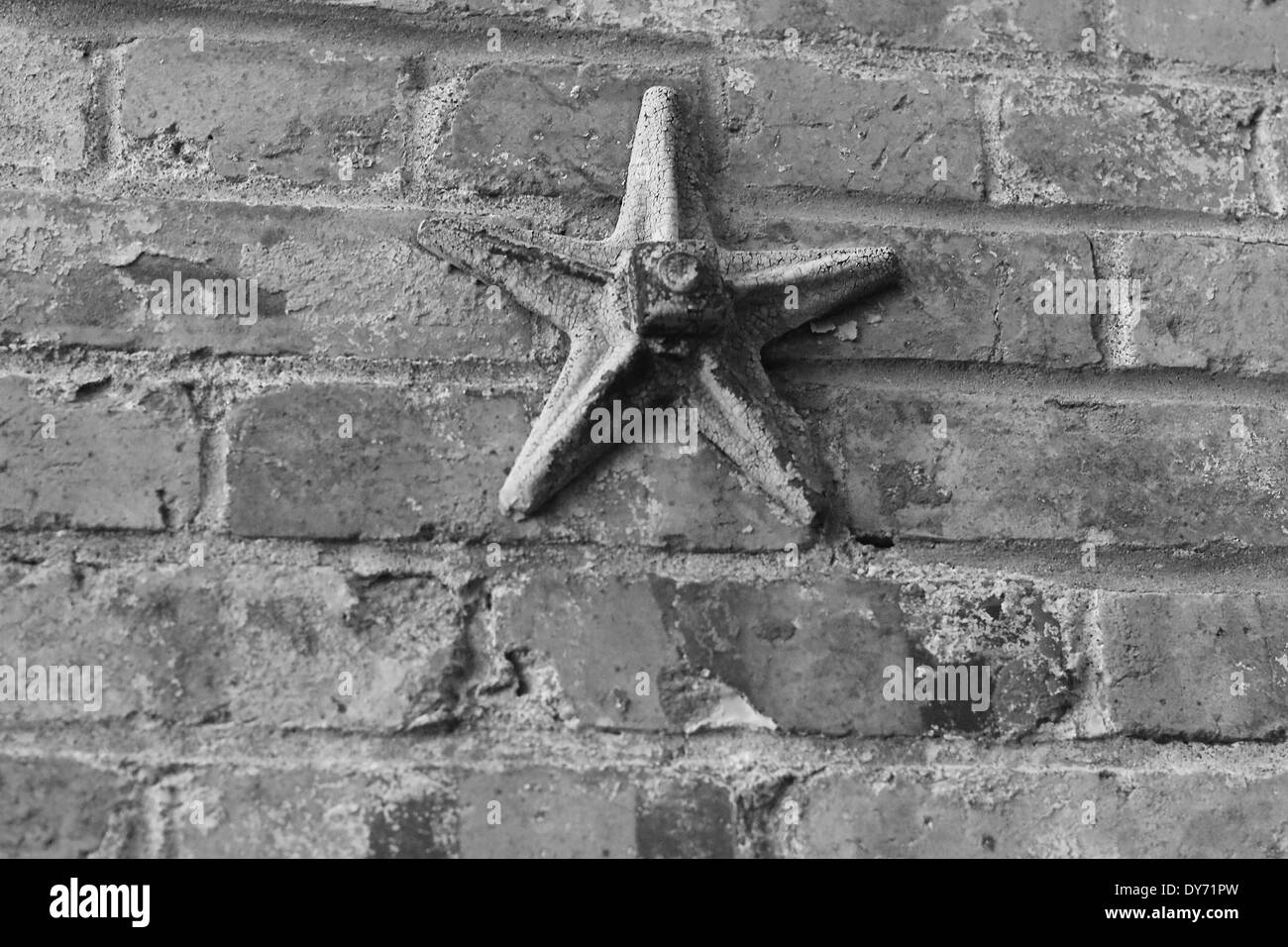 Cast Iron Wall Star or Wall Washer on Brick Wall in Maine Stock Photo