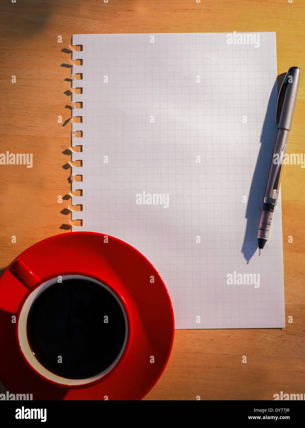 Overhead of graph paper coffee and pen Stock Photo