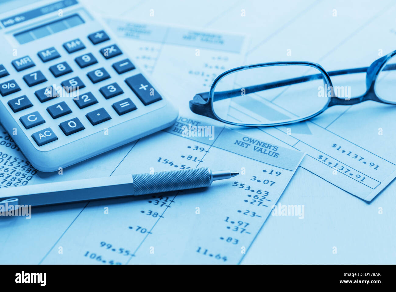Accounting workspace with calculator, pen and glasses Stock Photo