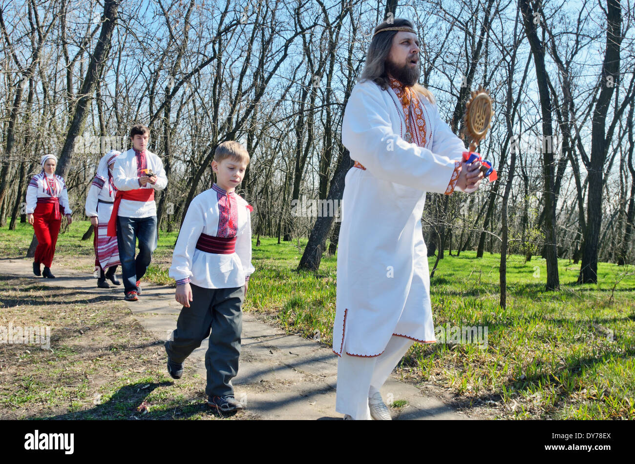 Pagan 'Easter' in Ukraine. Priest and worshipers in traditional clothes carry the sacred symbol around the sanctuary. Stock Photo