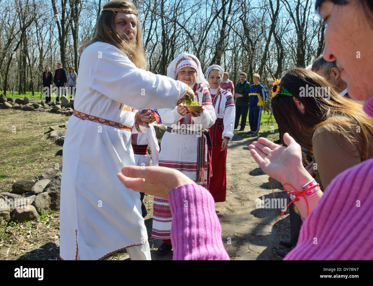 Pagan "Easter" in Ukraine. Priest bless worshipers by water and grass