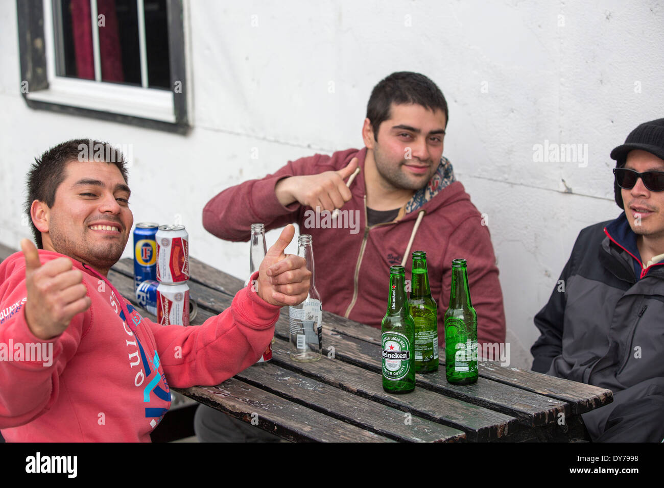 Young men drinking outside a pub in Port Stanley in the Falkland Islands. Stock Photo