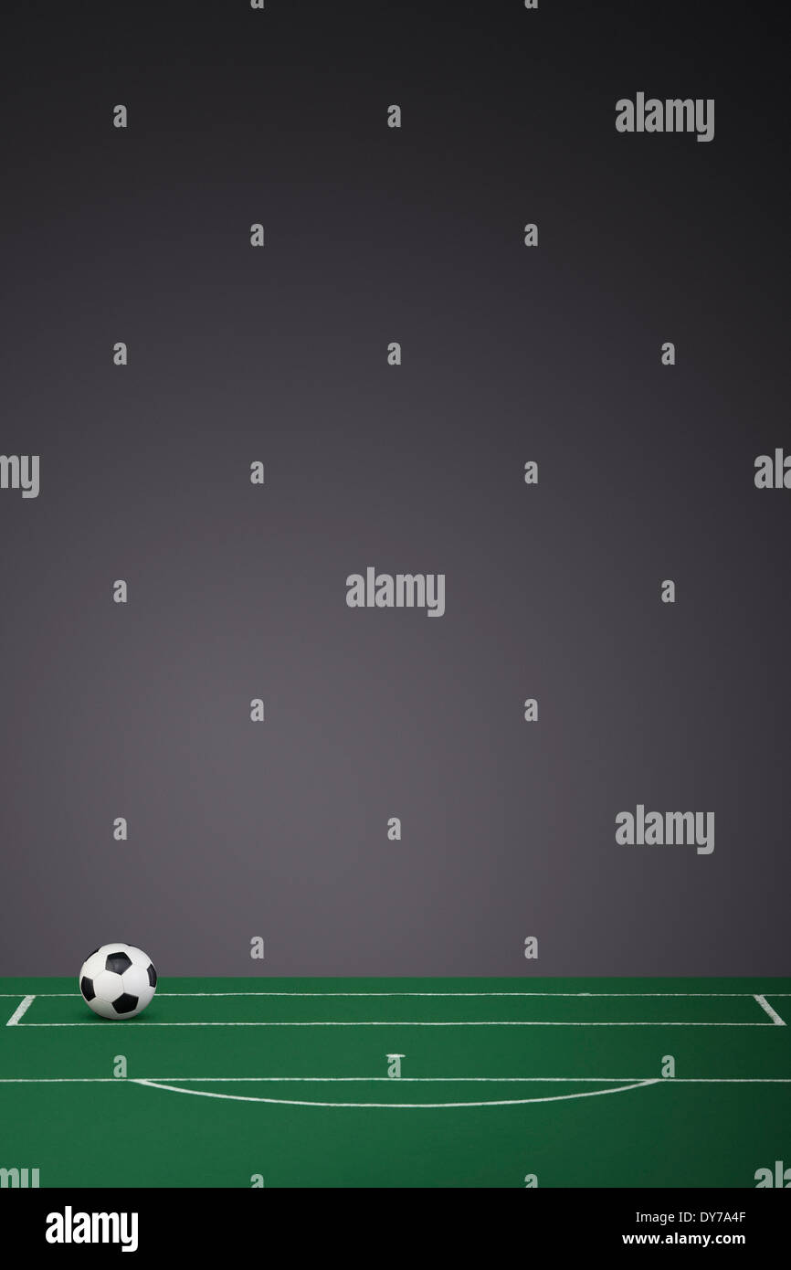 Black & White Leather Football on a fabric football pitch Stock Photo