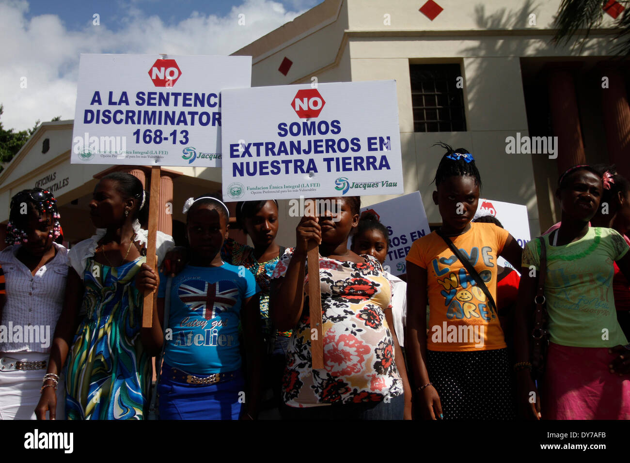 (140408) -- SANTO DOMINGO, April 8, 2014 (Xinhua) -- Dominican residents of Haitian descent hold banners during a protest outside National Palace, in Santo Domingo city, Dominican Republic, on April 8, 2014. A commission of Dominican Movement for Right, handed a letter to the executive branch demanding Dominican President Danilo Medina to present as soon as possible to the National Congress a Law of Recognition. The law fully restore the rights affecting some 200, 00 Dominicans of Haitian descent who have been denationalized by the judgement 168-13, issued by the Constitutional Court (CC), add Stock Photo