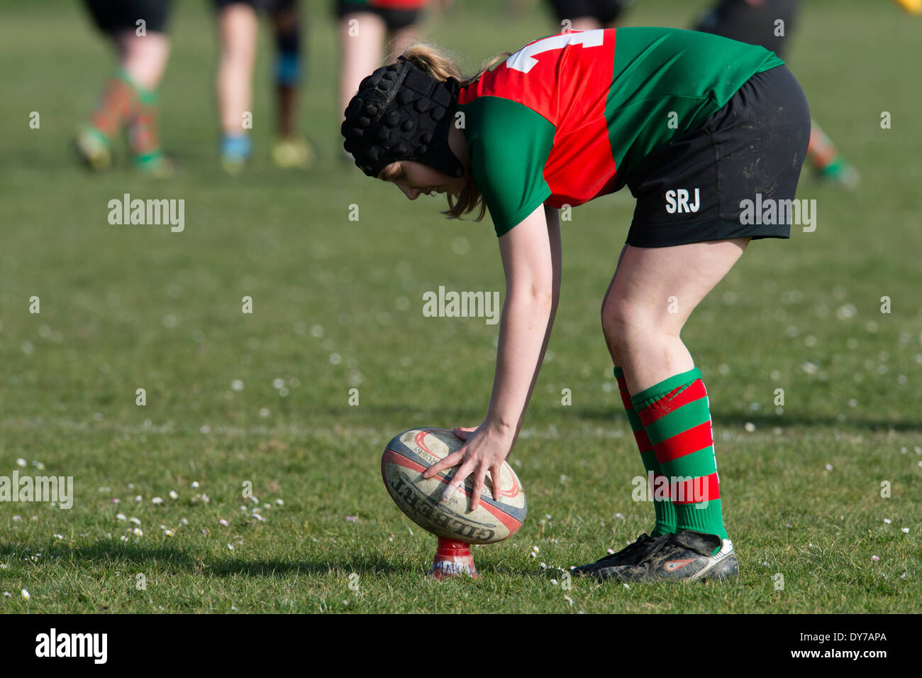 Aberystwyth university women (in red and green) playing rugby against Trinity St Davids university, Wales UK Stock Photo