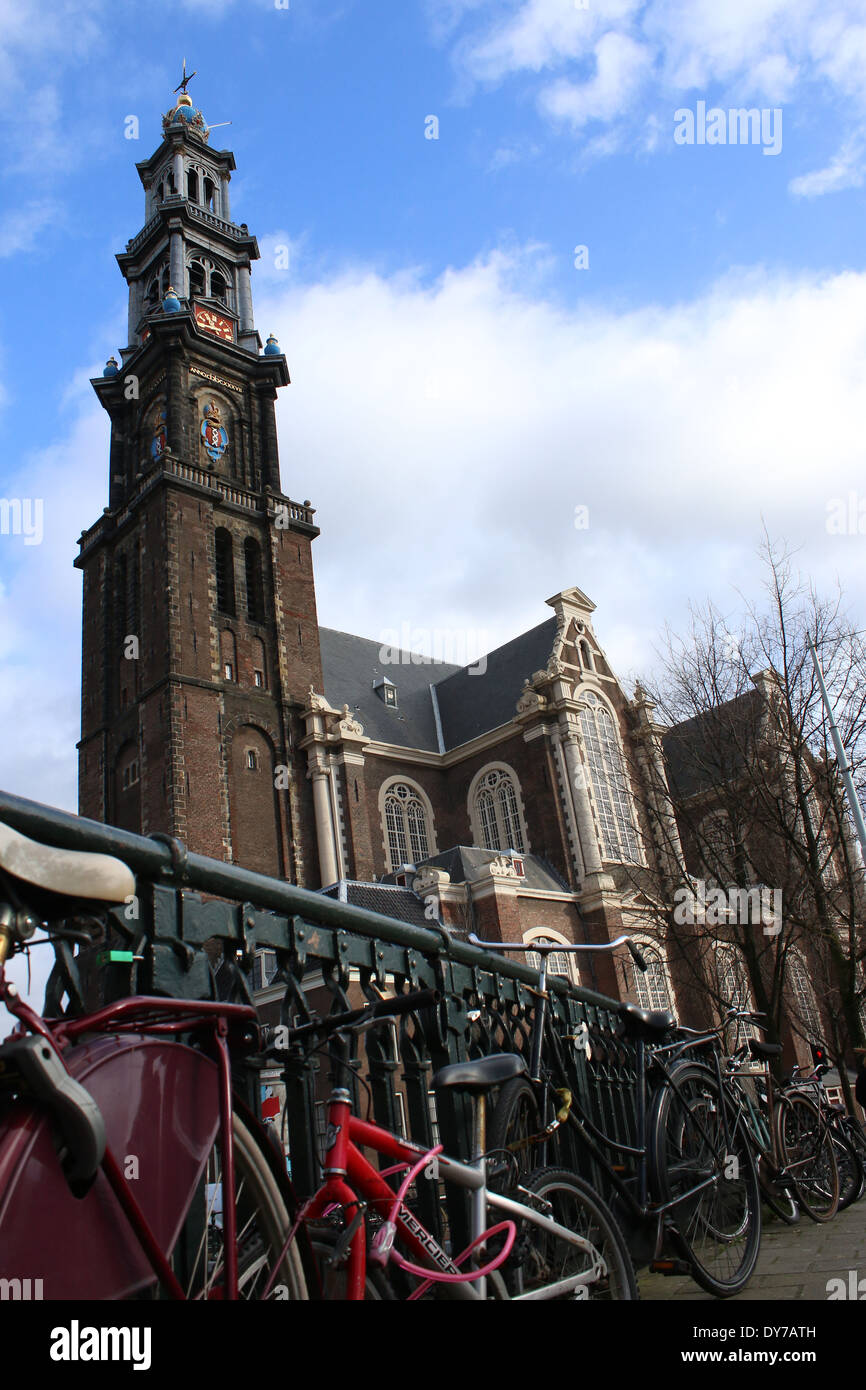 Westerkerk tower and church in Amsterdam with lots of bikes parked in foreground Stock Photo