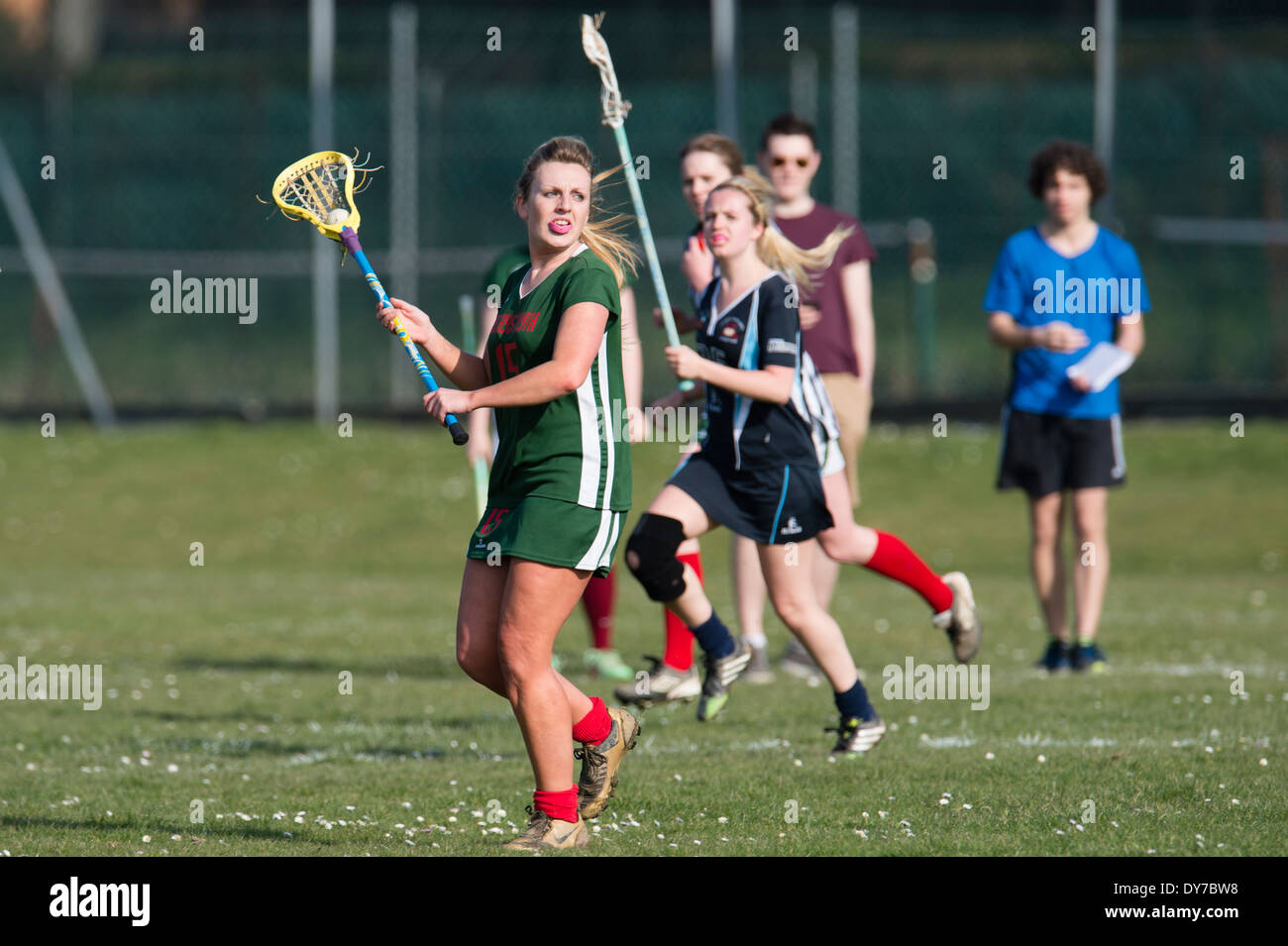 Aberystwyth university women's team (in green) playing lacrosse against Plymouth University, Wales UK Stock Photo