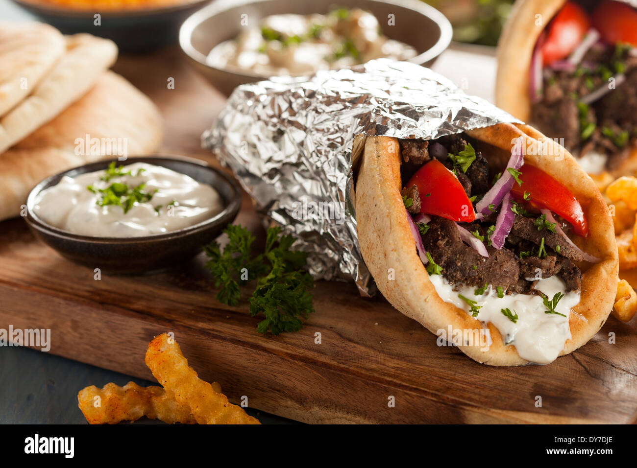 Homemade Meat Gyro with Tzatziki Sauce, tomatos and French Fries Stock Photo