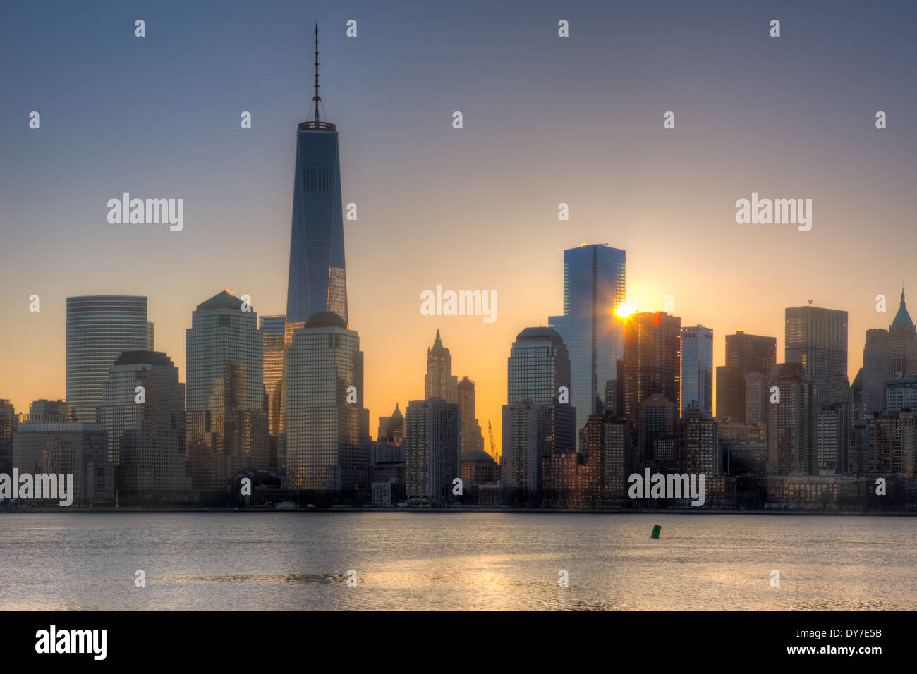 The sun rises next to 4 World Trade Center as the Freedom Tower (1 WTC) stands tall nearby in New York City. Stock Photo