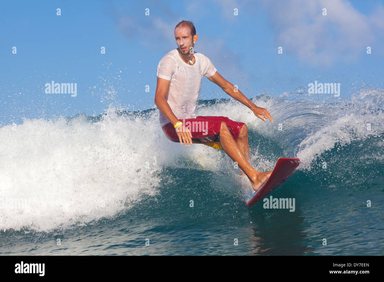 Surfing a wave in Indian ocean Stock Photo Alamy