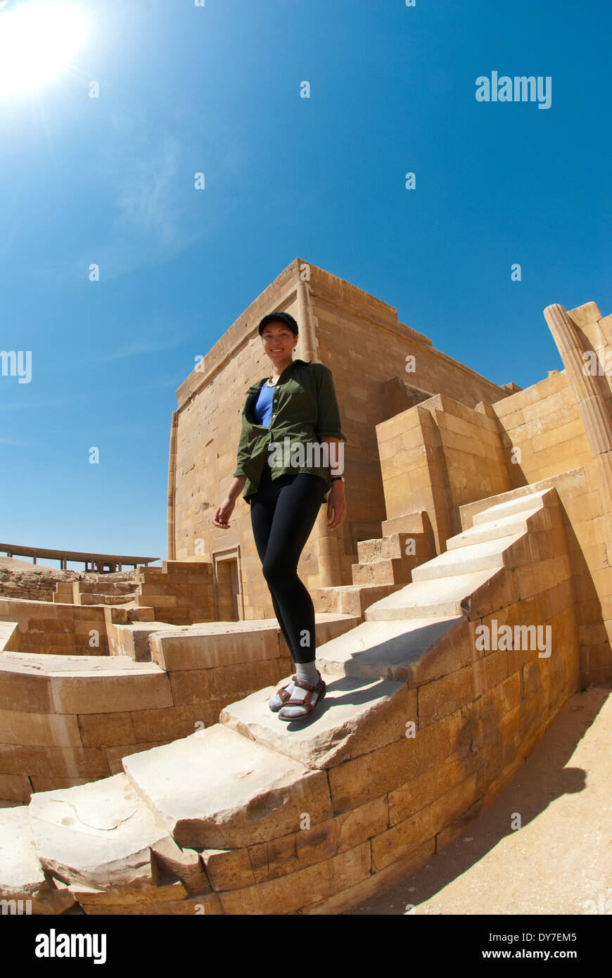 Young woman ( age 25) walking down steps at Saqqara temple in Egypt. Stock Photo