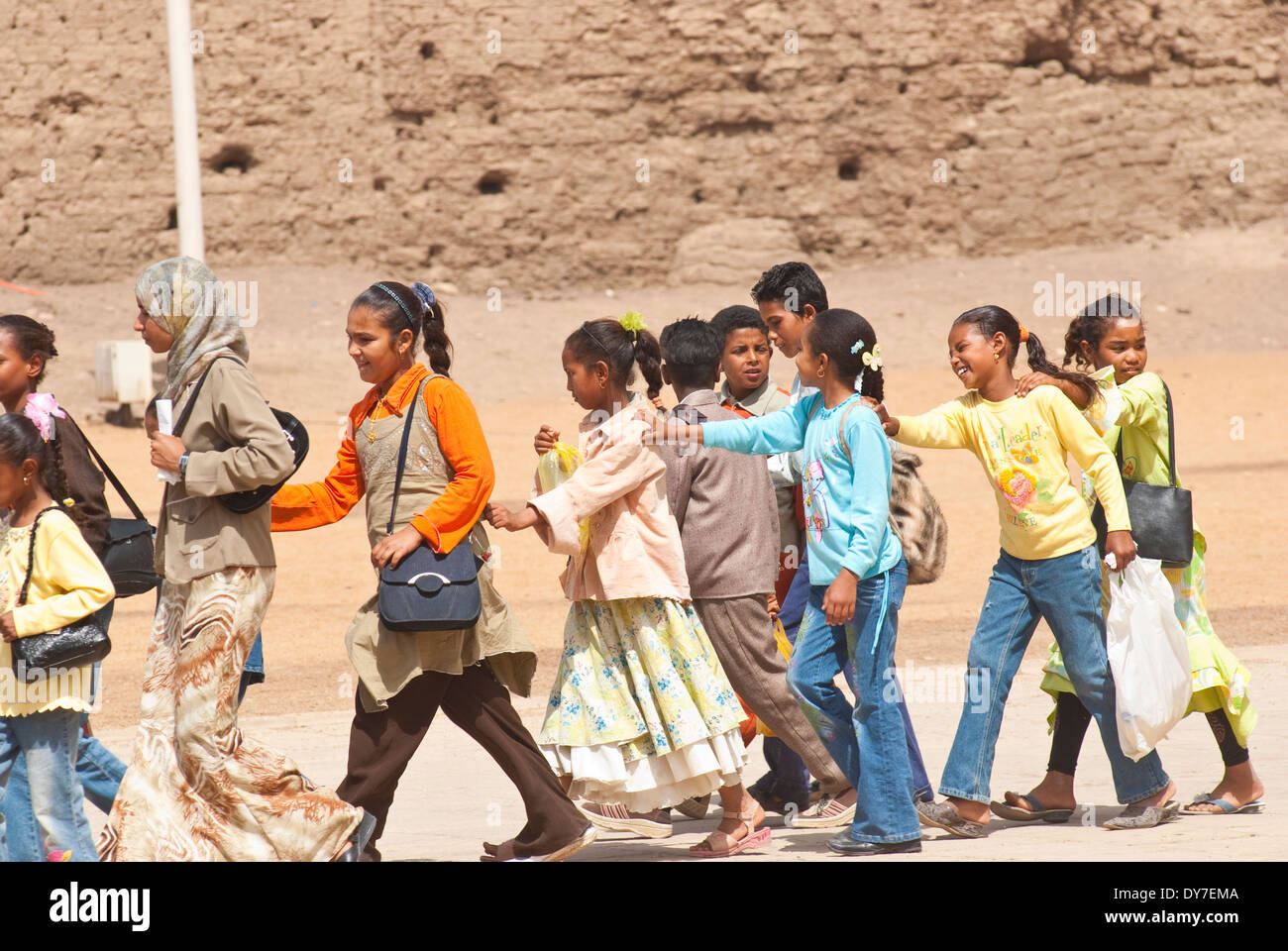 Group of school children walking in line with hands on shoulders, Cairo, Egypt. Stock Photo