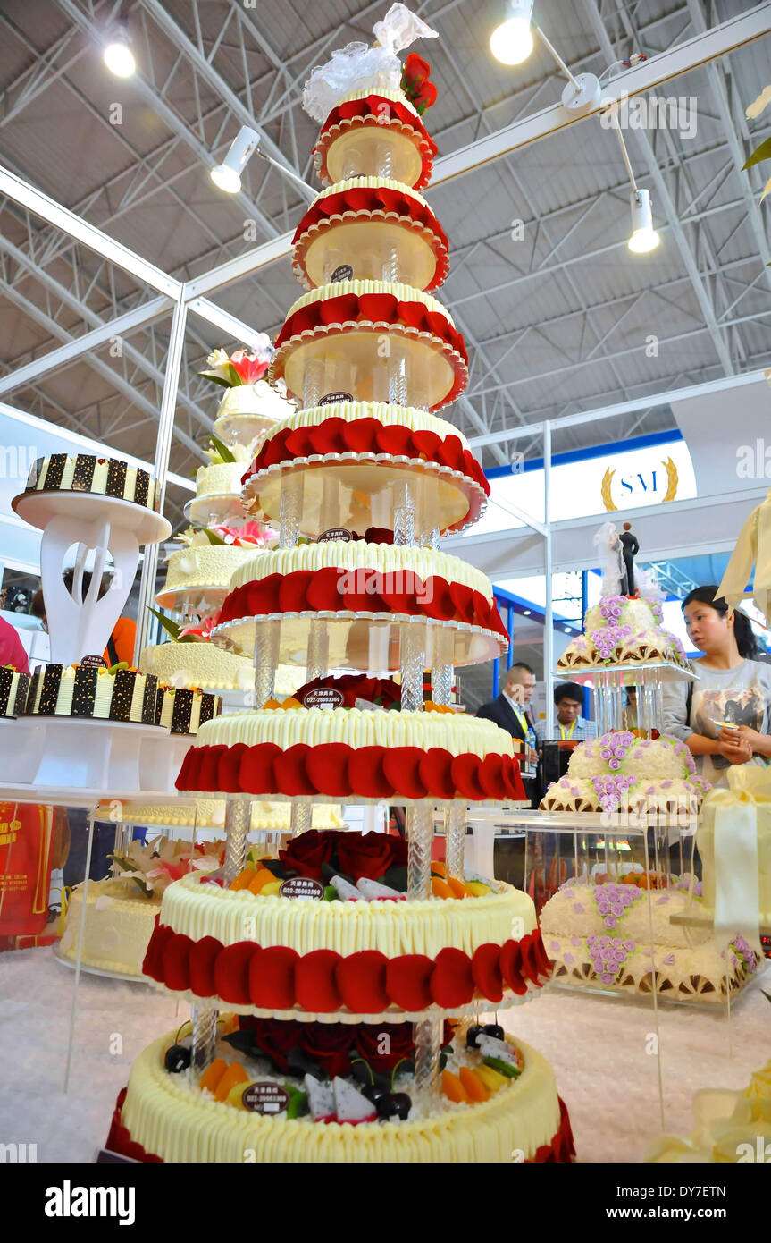 Beijing, China. 8th Apr, 2014. Visitors watch a tower cake model during  2014 China Beijing International Bakery, Icecream and Food Processing and  Packaging Exhibition in Beijing, capital of China, April 8, 2014.