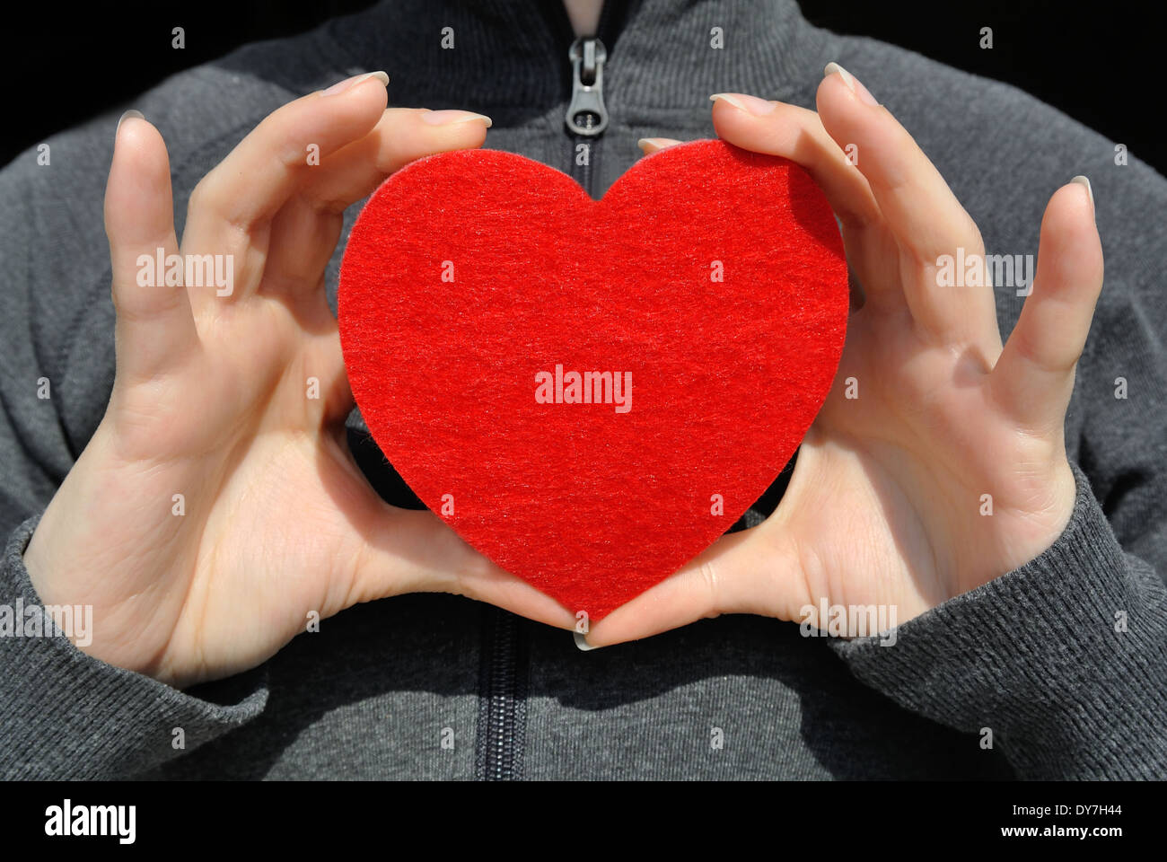 Girl with a red heart in her hand Stock Photo