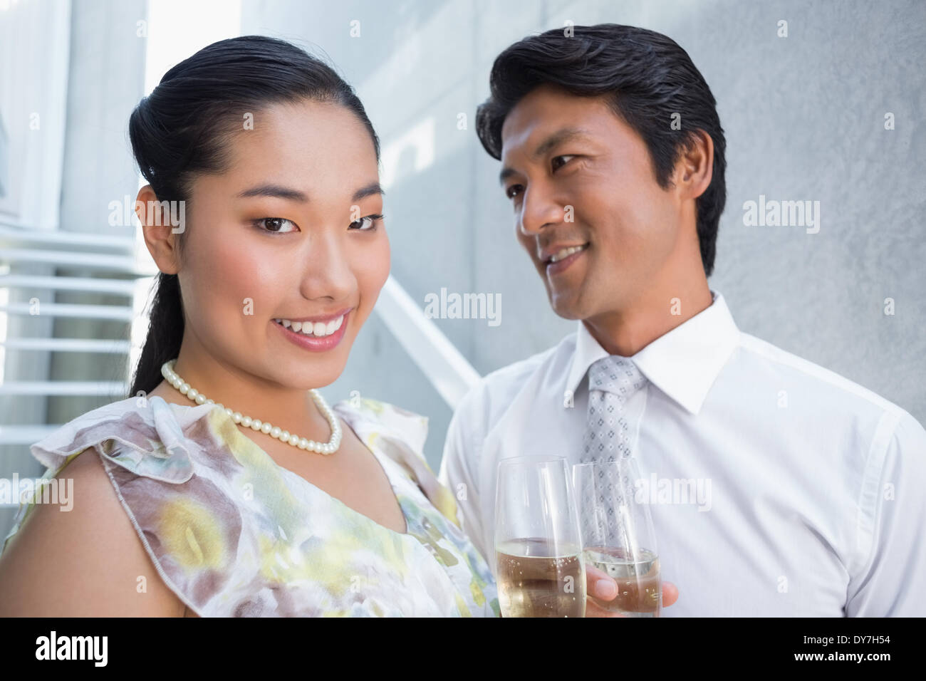 Happy couple dressed up for a date having champagne Stock Photo