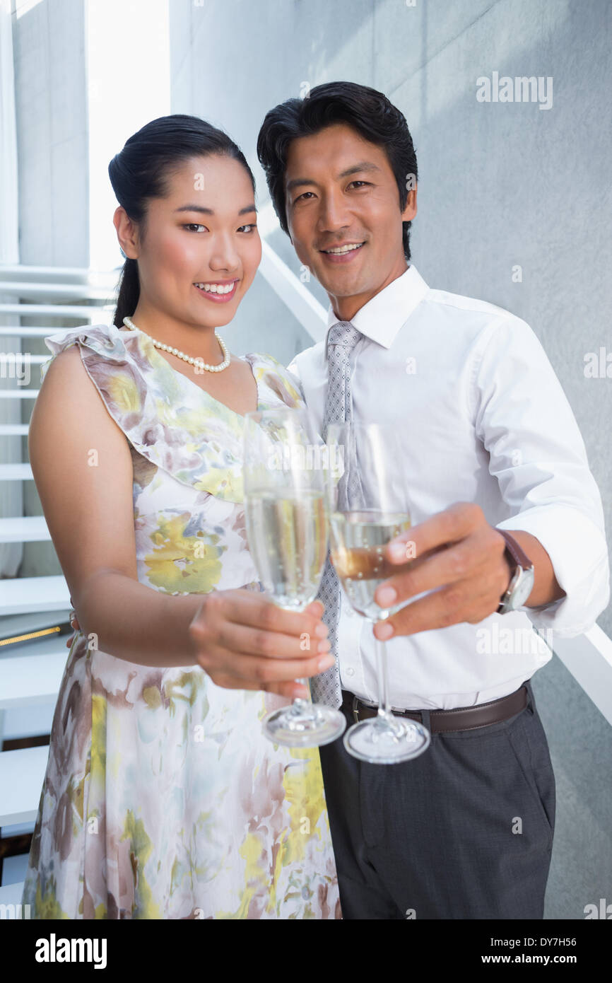 Happy couple dressed up for a date having champagne Stock Photo