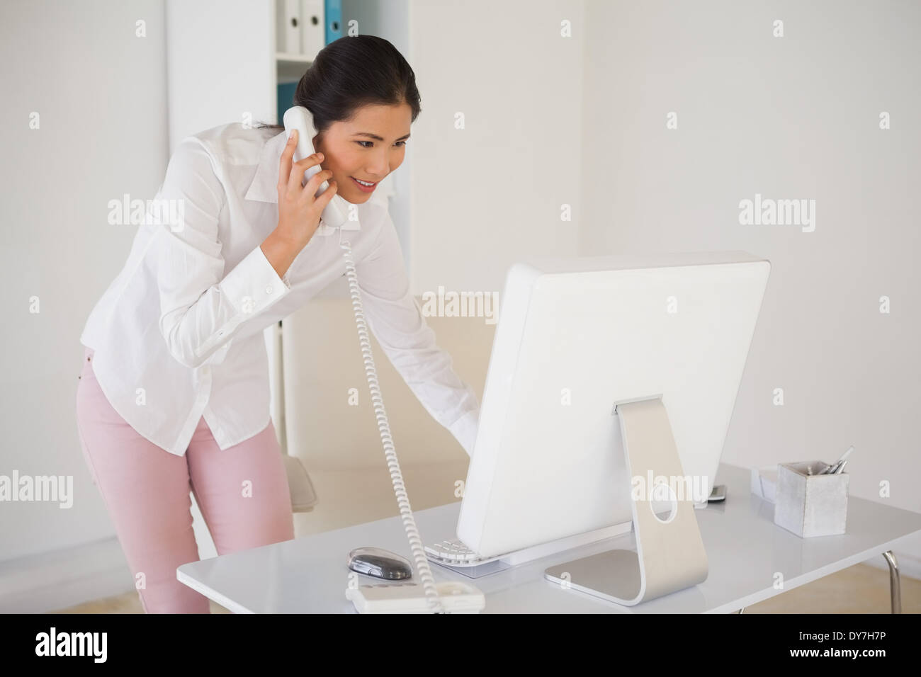 Casual businesswoman answering the phone Stock Photo