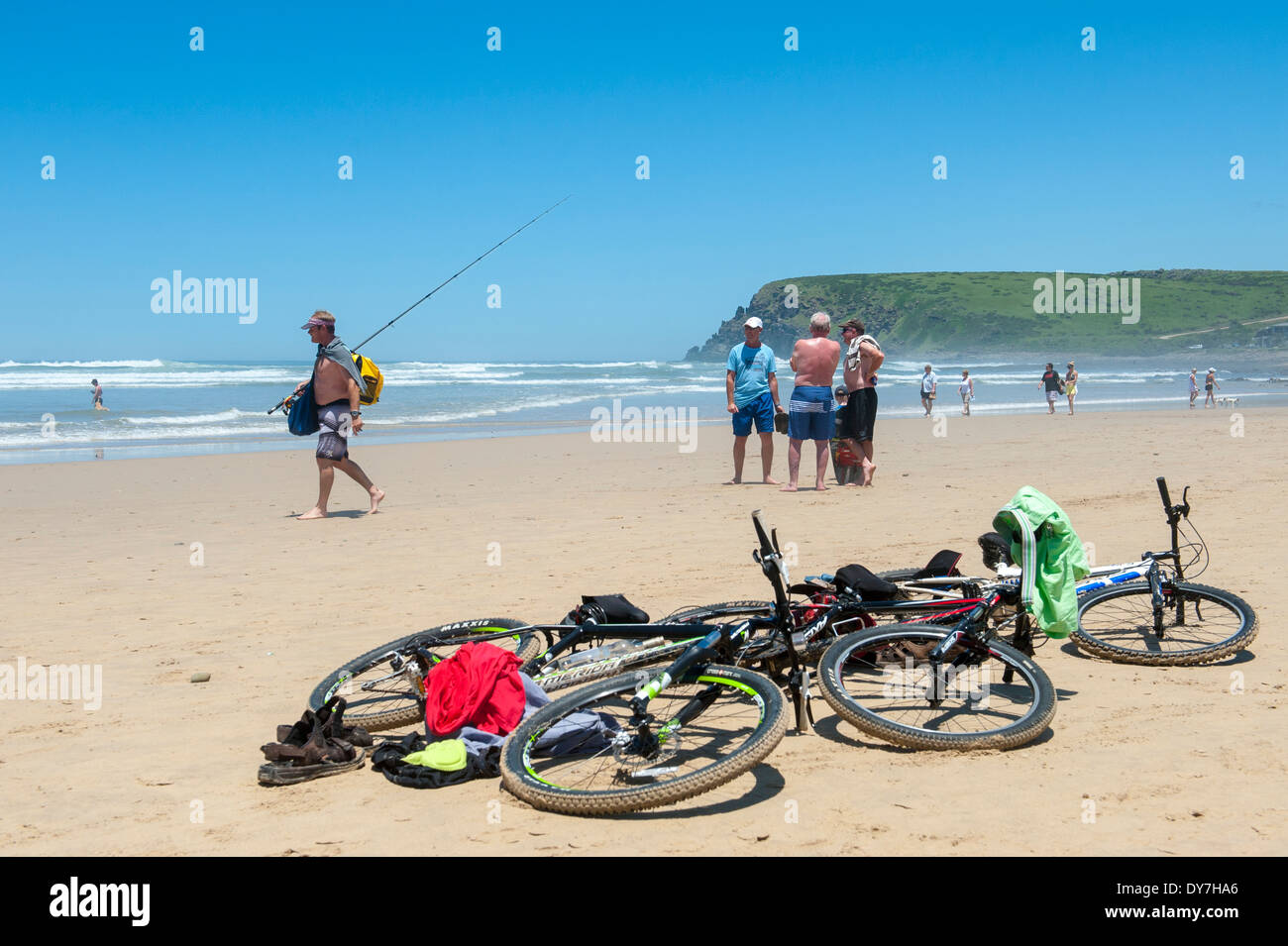 People chatting bicycles lying on the beach in Morgan Bay, Eastern Cape, South Africa Stock Photo