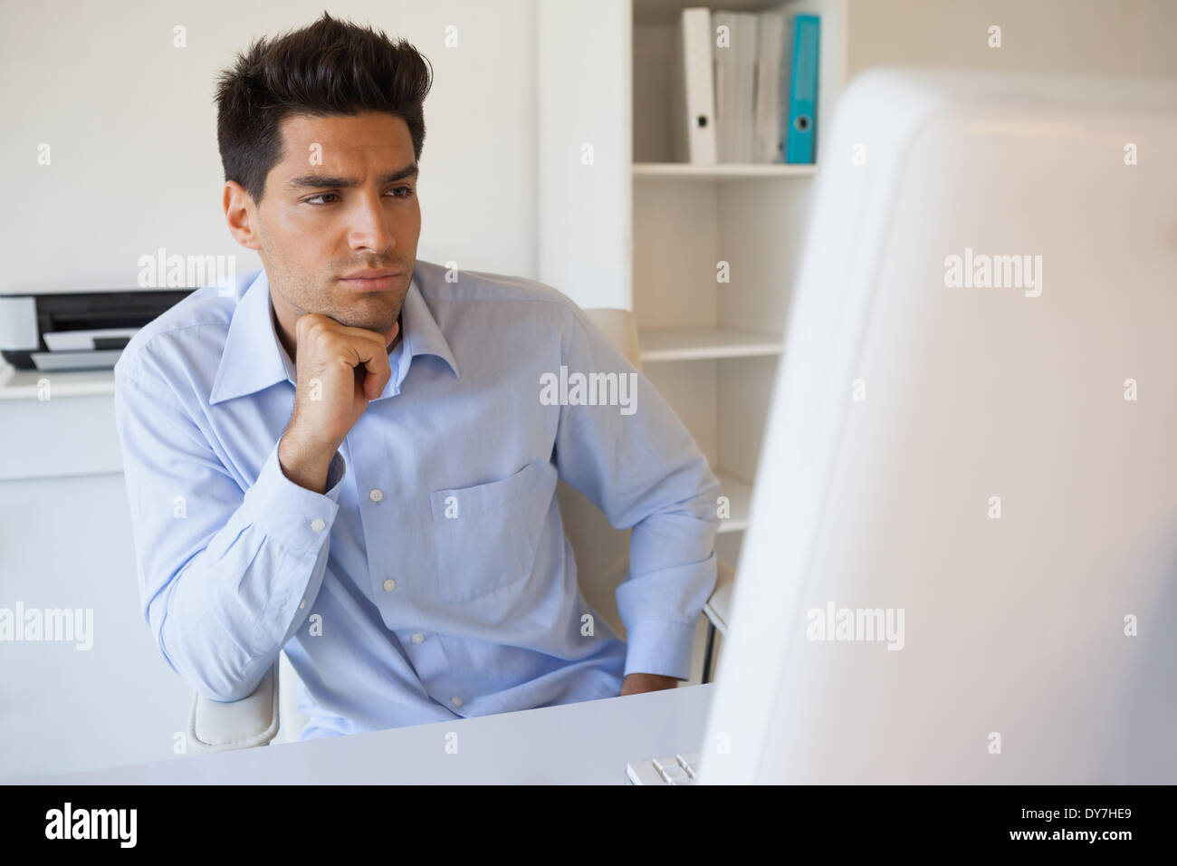 Casual businessman focusing at his desk Stock Photo