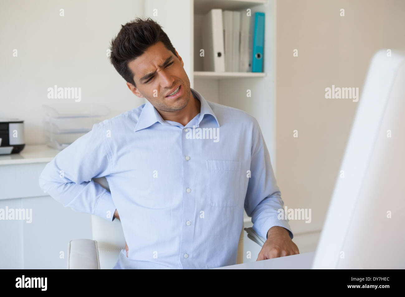 Casual businessman touching his sore back Stock Photo Alamy