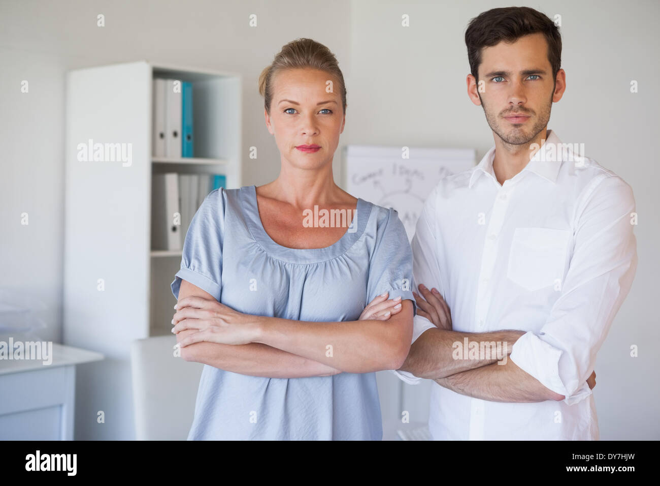 Casual business team looking at camera with arms crossed Stock Photo ...