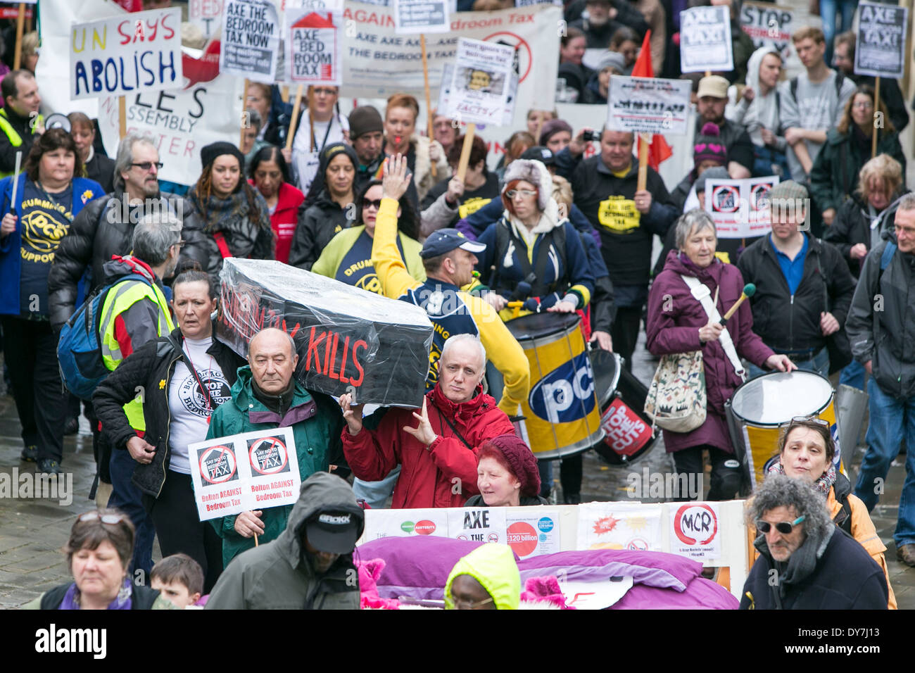 Protestors march through Manchester City Centre today (Sat 05/04/14) in opposition to the bedroom tax. Stock Photo